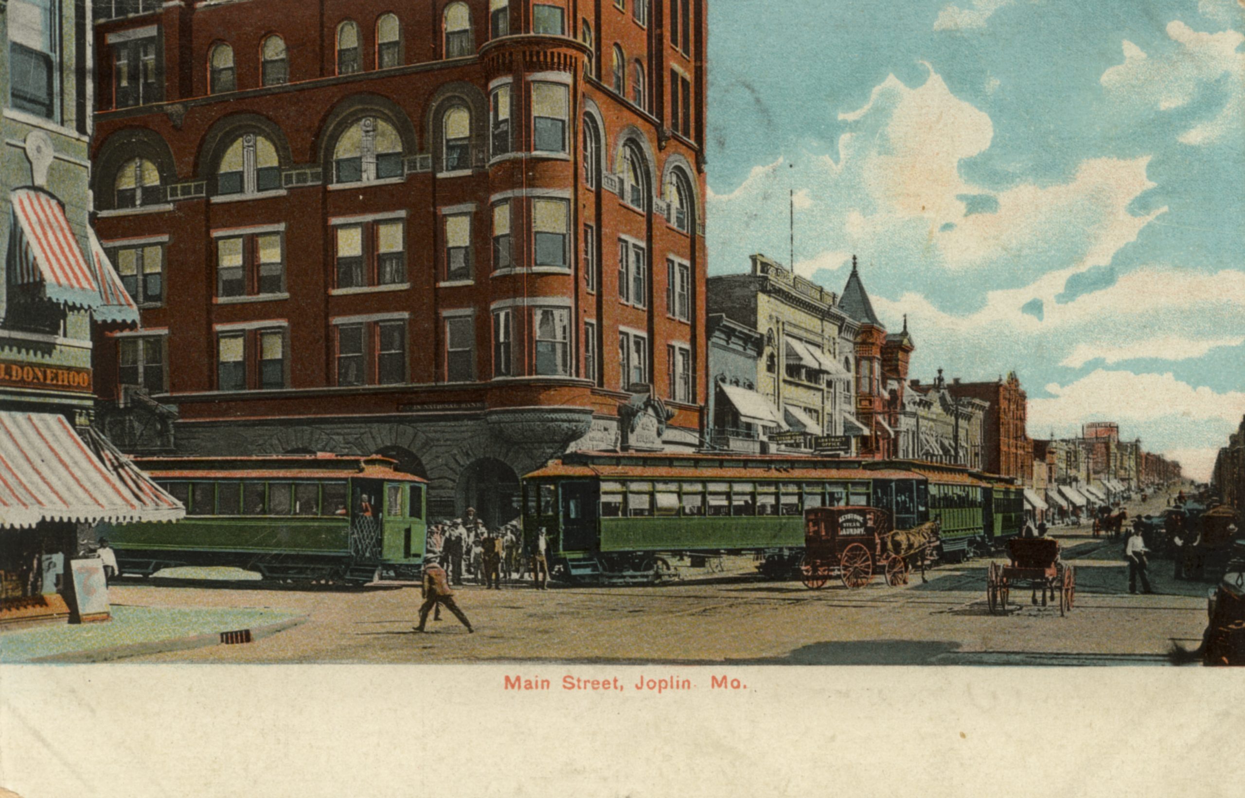 Trolley Cars, or streetcars, pass in front of the Keystone Hotel in Joplin, Missouri.